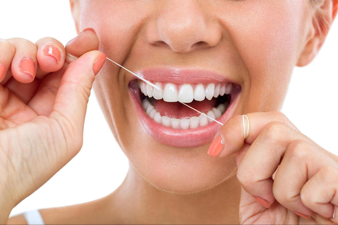 A woman flossing her teeth